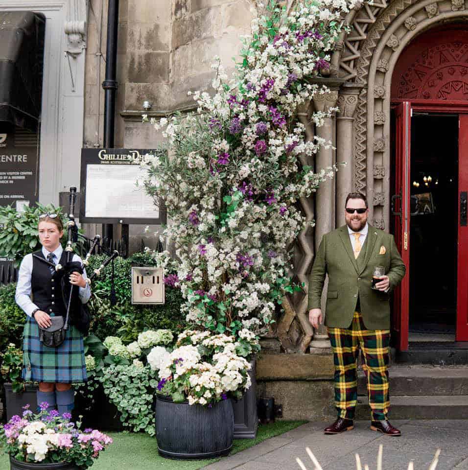 Mr Barrett wearing his made-to-measure green tweed jacket and yellow and green plaid trews for his wedding in Scotland