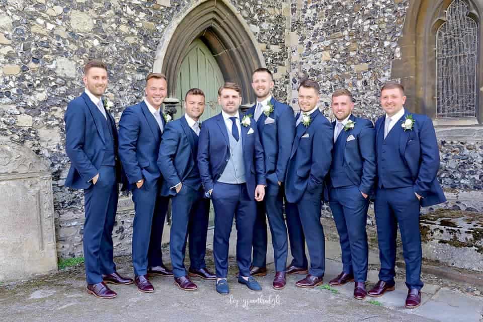 All in royal blue suits but the Groom wore a grey collarless DB waistcoat, blue tie and blue shoes